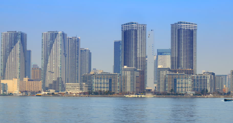 Towering apartment buildings and the blue sea on the waterfront of Tokyo Bay