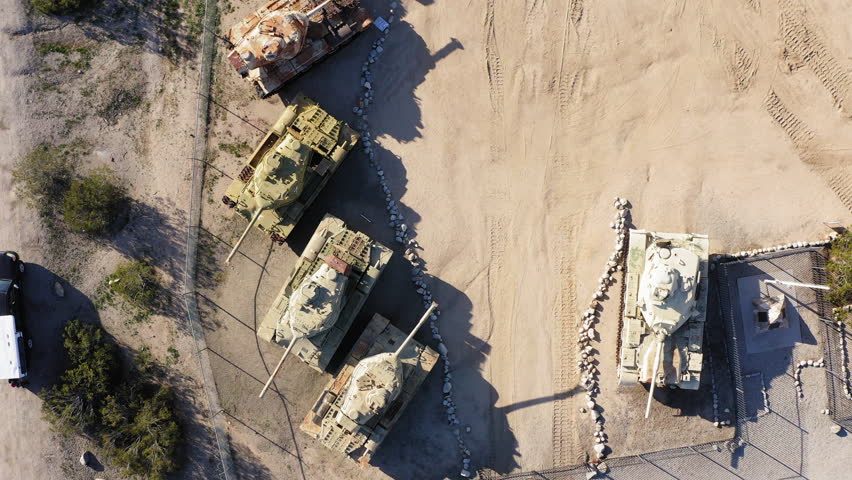 Stunning top-down aerial perspective of military tanks arranged in rows at the General Patton Memorial Museum in the desert
