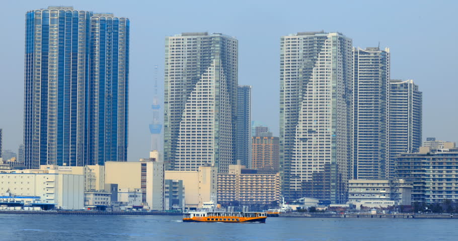 Towering apartment buildings and the blue sea on the waterfront of Tokyo Bay
