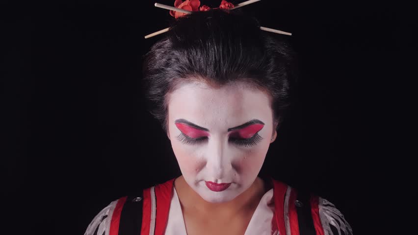 A close-up view of a charming beautiful young geisha woman in traditional japanese kimono 