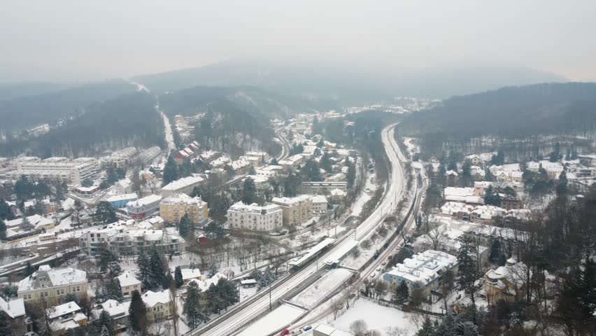 Aerial view of winter district of Vienna Austria with railway tracks and residential buildings