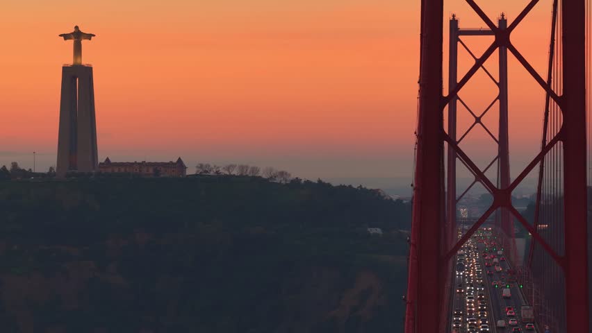 Aerial view of Lisbon, capital of Portugal. Sunrise at the bridge the 25 of April in the centre of Lisbon, Famous Cristo Rei statue with the bridge 25 de Abril drone view