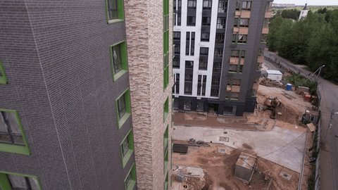 Drone Retreating Descending near Modern Apartment Building