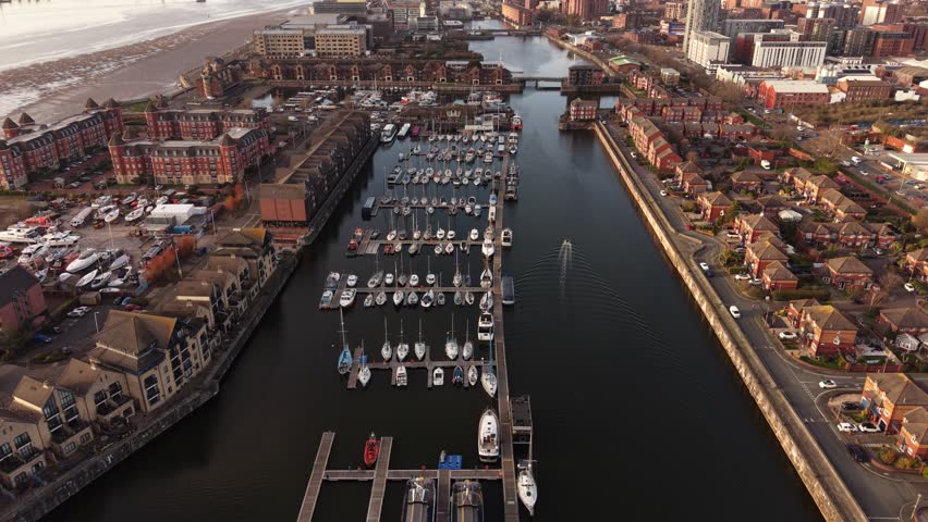 Aerial view showing the dock basin beside a small marina area with boats and walkways.