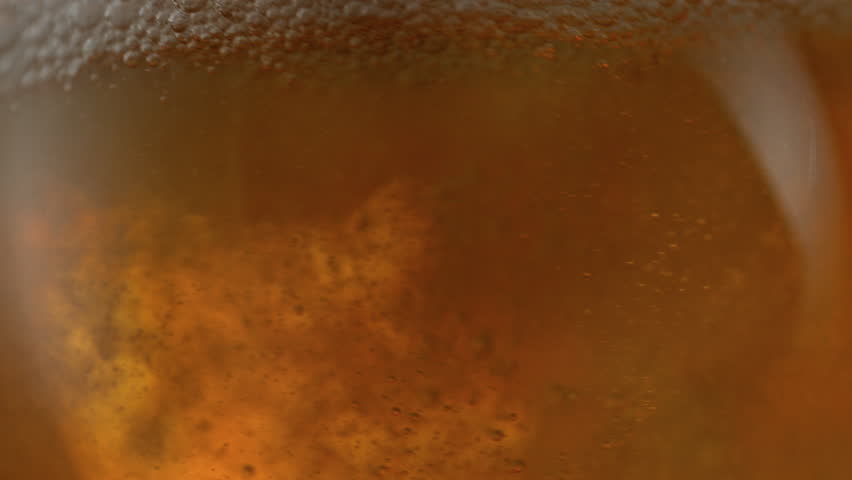 Super Slow Motion Shot of Rippling Fresh Beer With Bubbles at 1000fps.