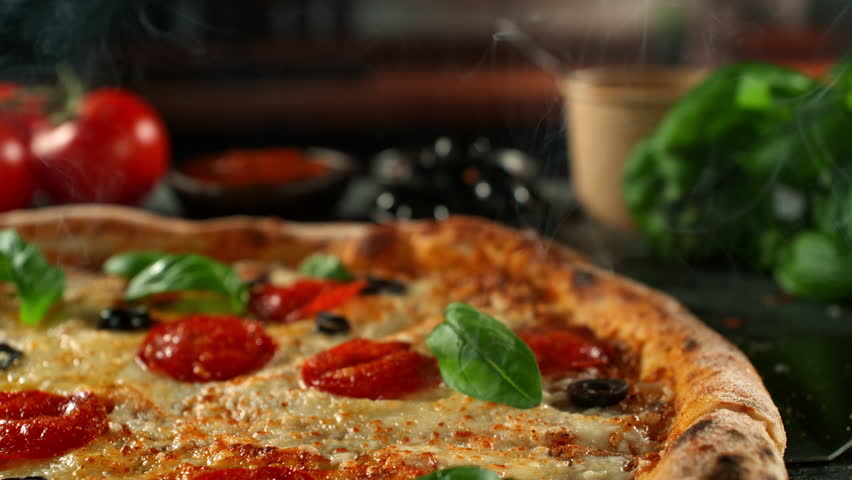 Ultra Slow Motion of Pizza with Melted Cheese Stretching Between Slices at 1000fps.