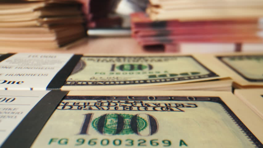 Banknotes and bag counter, Specialised police officer Counting dollar euro banknotes in crime lab with machine, cashed out criminal money, bitcoin changing, buying home flat in bank. 