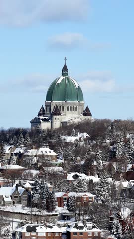 Saint Josephs Oratory dome above snowy Westmount and Montreal neighborhood on Mount Royal hill in winter, Quebec, Canada. g.