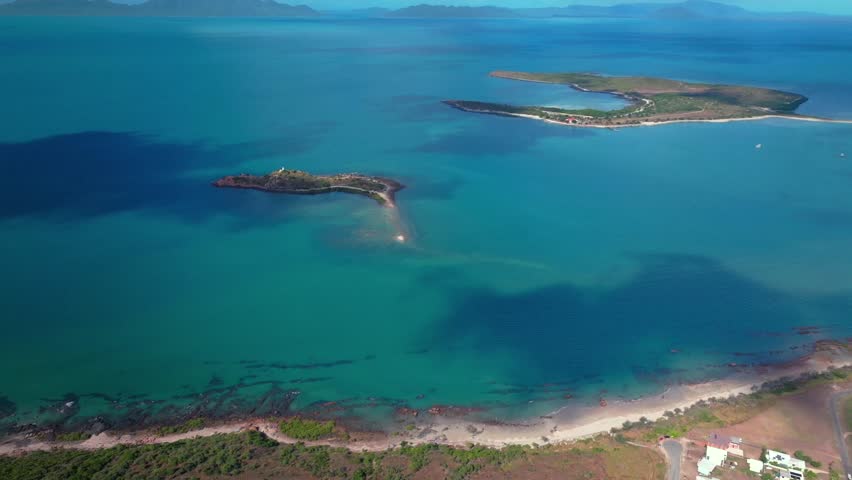 Horseshoe Bay Bowen Australia aerial drone ocean view nature landscape Airlie Beach Proserpine sunny blue sky Coral Sea Marina Harbor View Great Barrier Reef Whitsunday Region backwards pan up motion