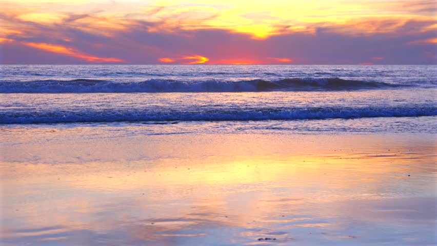 Pastel sunset over Pacific Ocean with waves on Santa Monica beach