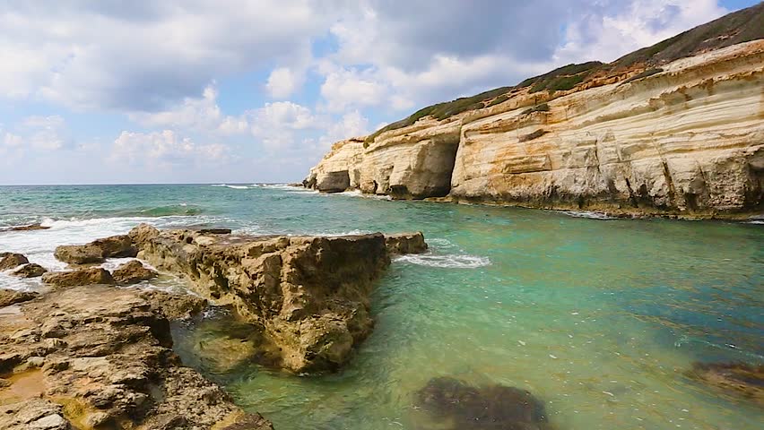 Idyllic seascape with waves washing over rocks at the pegeia sea caves in paphos, cyprus