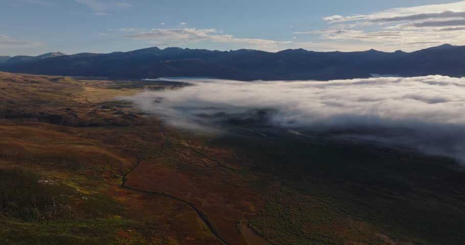 Drone panorama of fog rolling over Grand Lake Colorado mountains, panoramic aerial backdrop background, nobody