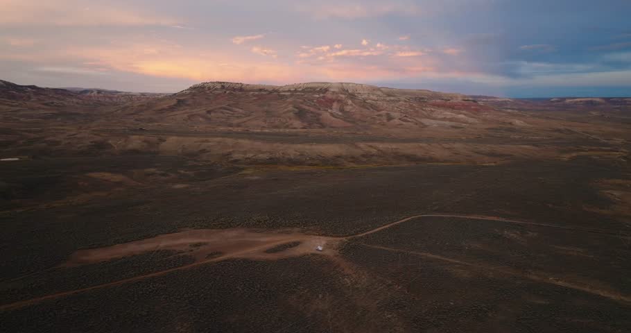 Aerial view of high desert plateau with layered ridges under warm sunset light in Wyoming