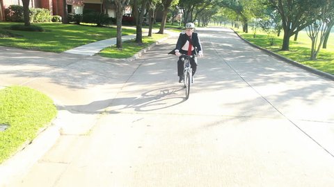 A businessman practices environmentally sustainable living by using a bicycle instead of his car for transportation.
