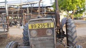 Old rusty tractor on a farm, front view establisher - Powered by Shutterstock - Get 15% off with code: PIKWIZARD15