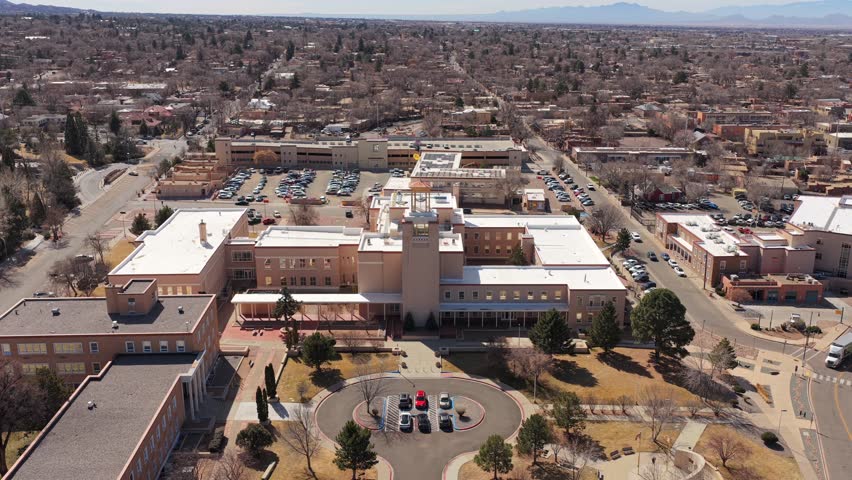 Fly forward toward the main administrative building for the State of New Mexico. This 4K perspective highlights the heart of the Santa Fe government district.