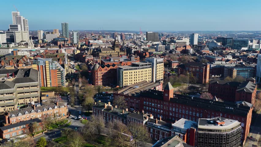 Aerial drone footage of the British city of Leeds showing the Leeds Town Hall historical building and  local businesses in the town