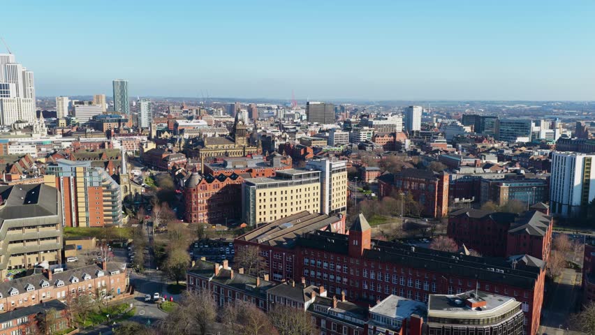 Aerial drone footage of the British city of Leeds showing the Leeds Town Hall historical building and  local businesses in the town
