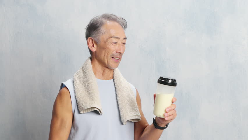 Sports image of a senior man drinking protein
