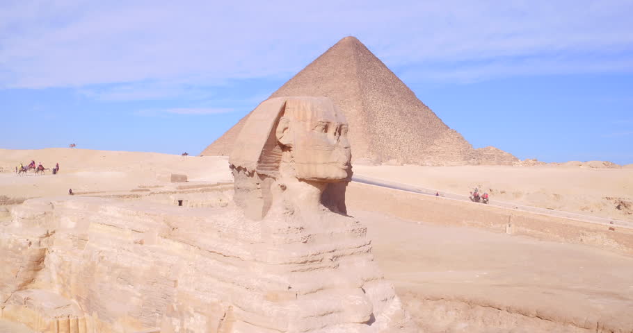 Close aerial drone shot of the Great Sphinx with the Pyramids of Giza in the background, Giza, Egypt.
