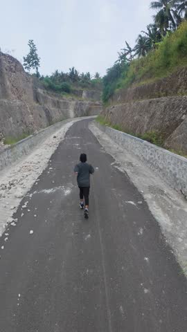 Man Running on a Scenic Road Outdoors