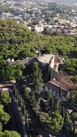 Gibralfaro Castle overlooking Málaga city and urban streets below. Vertical aerial reverse