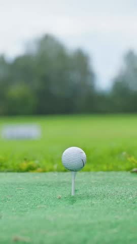Vertical Close-up Golfer Striking Golf Ball. Golf Ball at Impact, Professional Player Striking Ball. Person Playing Golf On Golf Course. Business Target or Goal Concept. Success. Luxury Lifestyle.