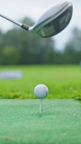 Vertical Close-up Golf Ball, Professional Player Preparing Hit Ball. Man Playing Golf On Golf Course. Golfer Taking a Swing. Business Target or Goal Concept. Success. Luxury Lifestyle. Slow motion.