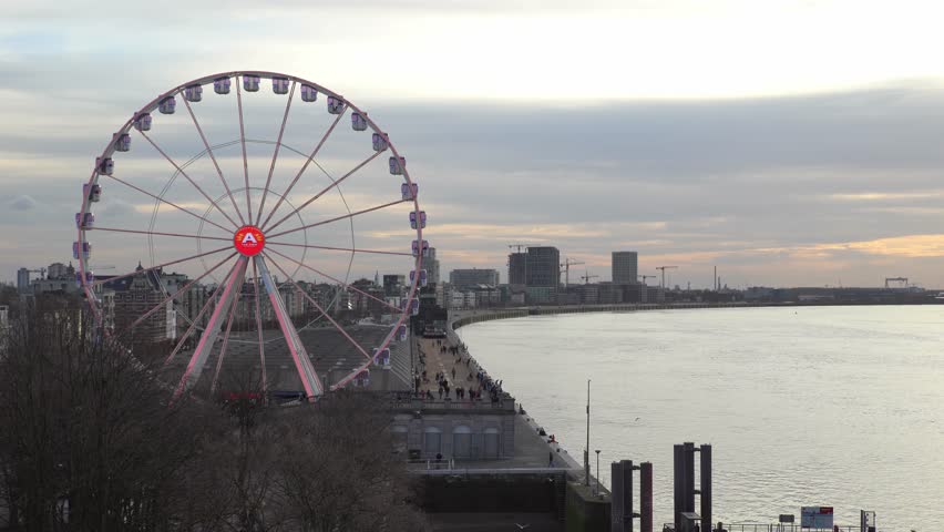 Ferris wheel agains a background of Antwerp city skyline