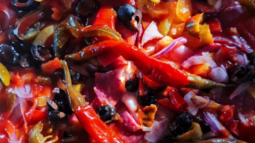 Spicy vegetarian pizza with roasted peppers, olives, and red onion
