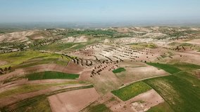 Aerial view of olive groves and cultivated farmland across rolling hills in rural Morocco creating scenic agricultural countryside landscape - Powered by Shutterstock - Get 15% off with code: PIKWIZARD15