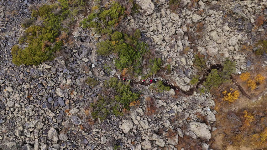 Hikers on Rocky Mountain Trail Drone View