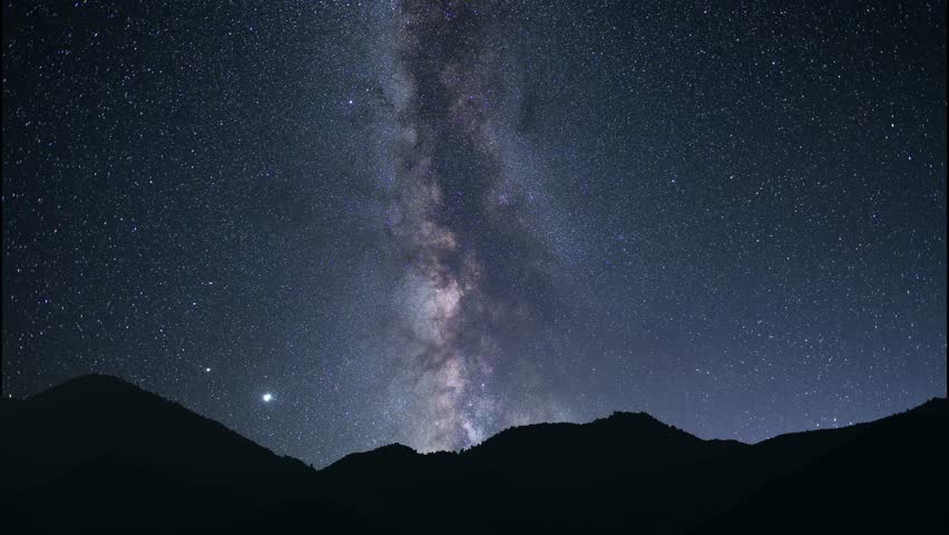 Night landscape, mountains under bright colorful milky way galaxy. Space, night scene time lapse.