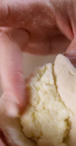 Stuffing and Pinching Traditional Polish Pierogi, Close-Up of Hands 4K Vertical