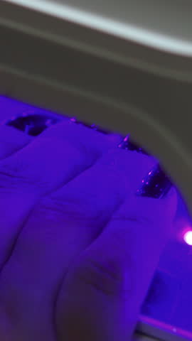 Purple Light Nail Hardening Process, Nail Polish Is Being Hardened By Ultraviolet Light In Salon Curing Unit. Media