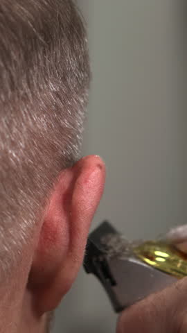 Caucasian Man Receiving Earline Trim With Trimmer Closeup Careful Outlining Barber Hands Steady. Media