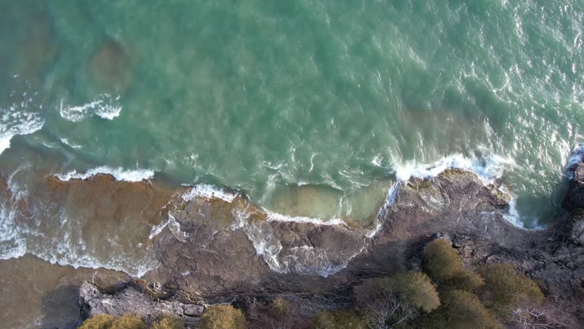 Aerial view of Lake Michigan coast line in Door County Wisconsin.  Drone over rugged shore with waves crashing.