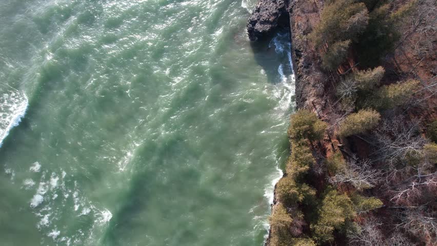 Aerial view of Lake Michigan coast line in Door County Wisconsin.  Drone over rugged shore with waves crashing.