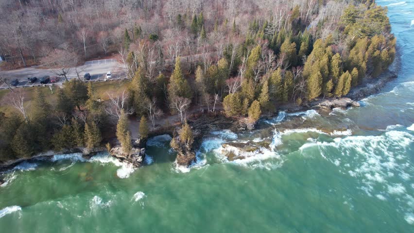 Aerial view of Lake Michigan coast line in Door County Wisconsin.  Drone over rugged shore with waves crashing.