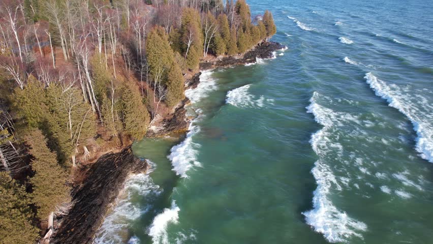 Aerial view of Lake Michigan coast line in Door County Wisconsin.  Drone over rugged shore with waves crashing.