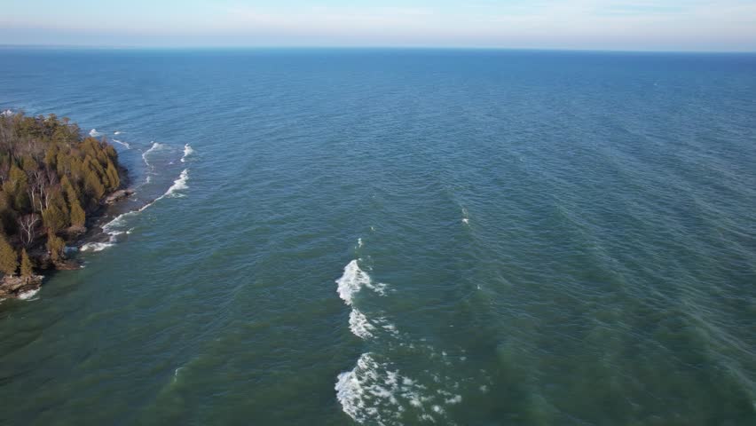 Aerial view of Lake Michigan coast line in Door County Wisconsin.  Drone over rugged shore with waves crashing.