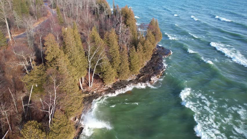 Aerial view of Lake Michigan coast line in Door County Wisconsin.  Drone over rugged shore with waves crashing.