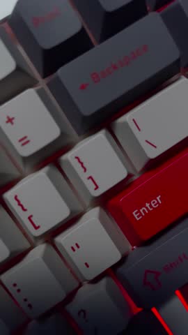 RGB mechanical keyboard close-up. Lateral camera slide over illuminated gaming keys with colorful backlight.