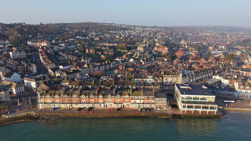 Aerial Drone Flyover of Swanage Bay and Jurassic Coastline in Dorset, UK, a dynamic aerial video of Swanage, a picturesque seaside town on the Jurassic Coast in Dorset, England.