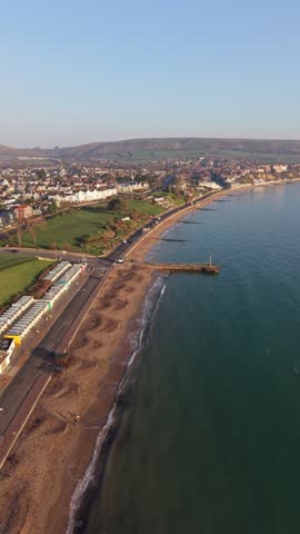 Aerial Drone Flyover of Swanage Bay and Jurassic Coastline in Dorset, UK, a dynamic aerial video of Swanage, a picturesque seaside town on the Jurassic Coast in Dorset, England.