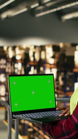 Vertical Video Isolated mockup on laptop with black woman staff handling cargo, contributing to e-commerce distribution operations. Manual labor supporting express delivery and supply chain control.