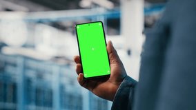 Chroma key smartphone used by server room employee to monitor electronics. Isolated screen mobile phone used by system administrator to manage enterprise cloud computing IT solutions, camera B - Powered by Shutterstock - Get 15% off with code: PIKWIZARD15