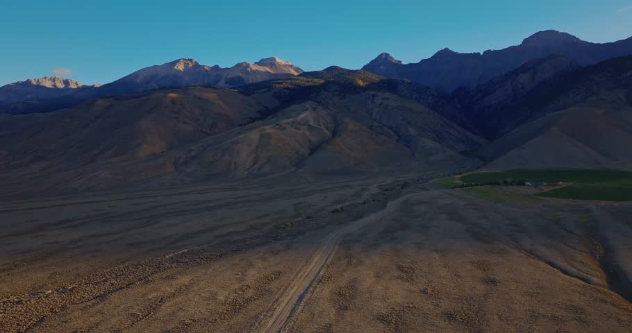 Aerial view of Highway 93 across open valley with Borah Peak rising in background Idaho