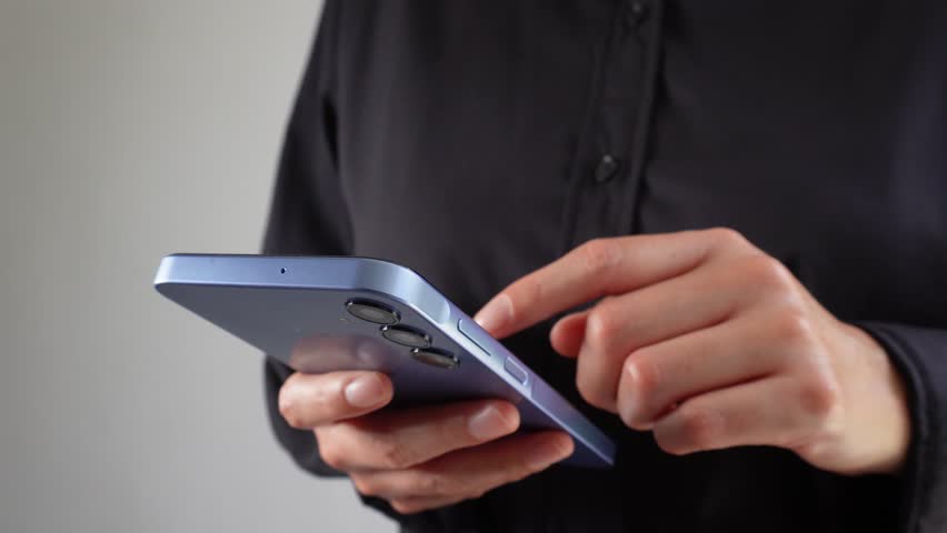 Businesswoman holding a smartphone with an animated avatar icon, a checkmark, and the word "Recruitment." Finding the right staff.