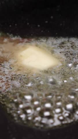 Frying onion on pan. Cooking dinner. Closeup. Vertical footage